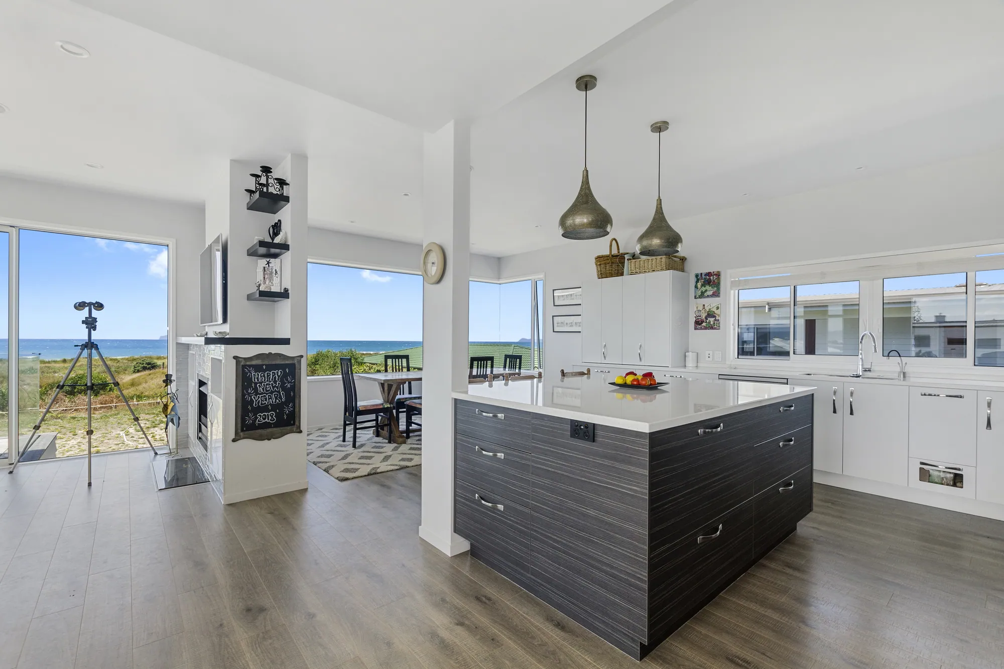 Renovated kitchen and living opening onto the dunes at Bream Bay