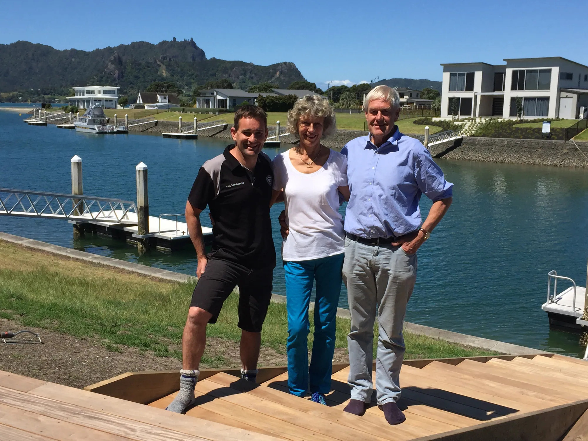 The Cogan team with clients on the new deck steps of a canal-front home