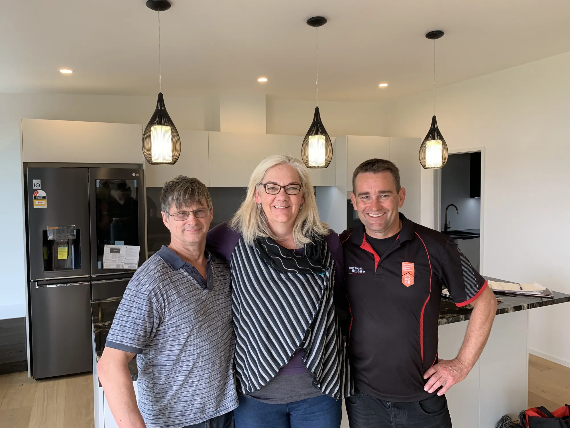 The Cogan team with clients in the kitchen of their new home