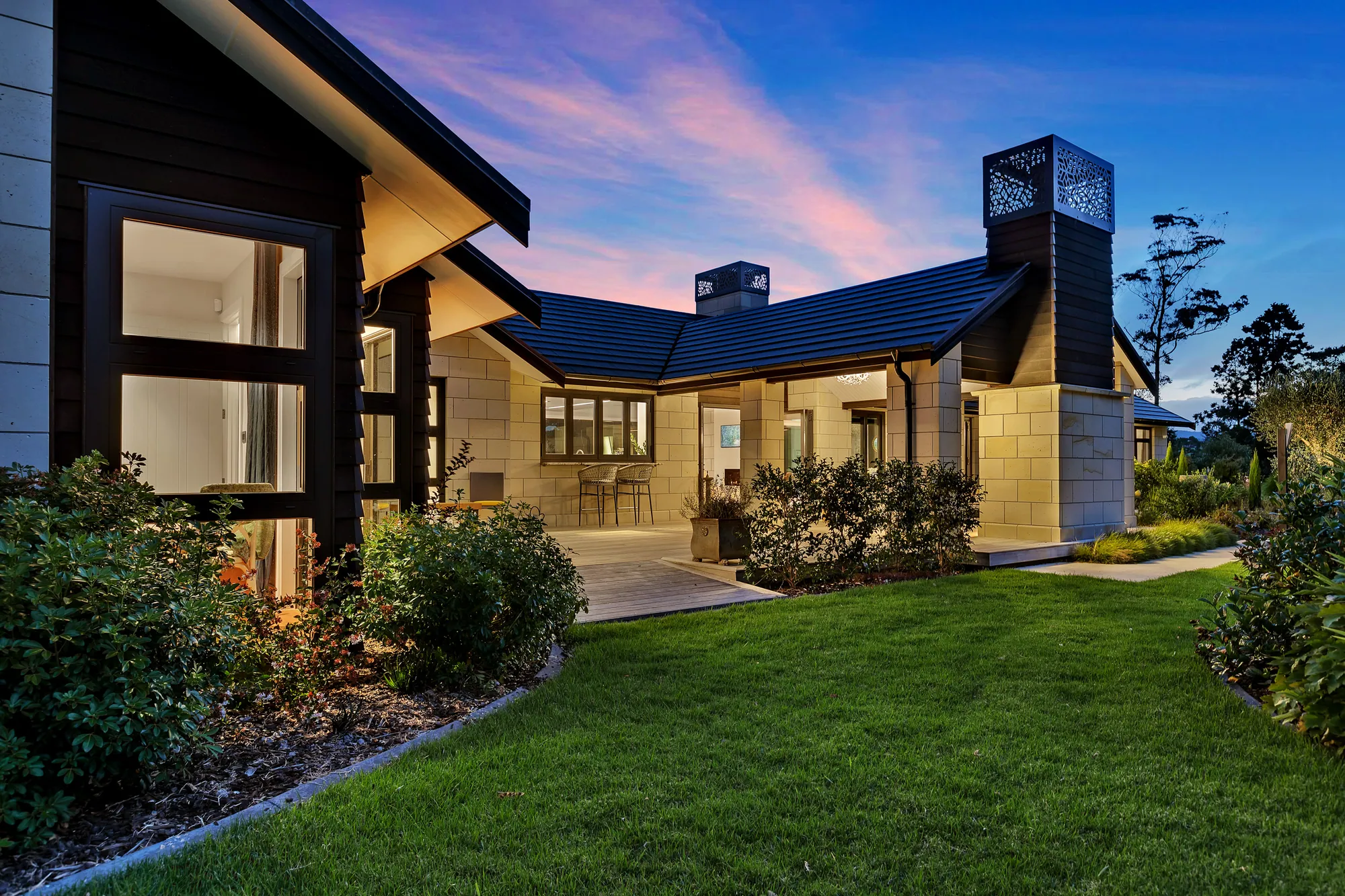 Custom Cogan home at dusk under a pink sky