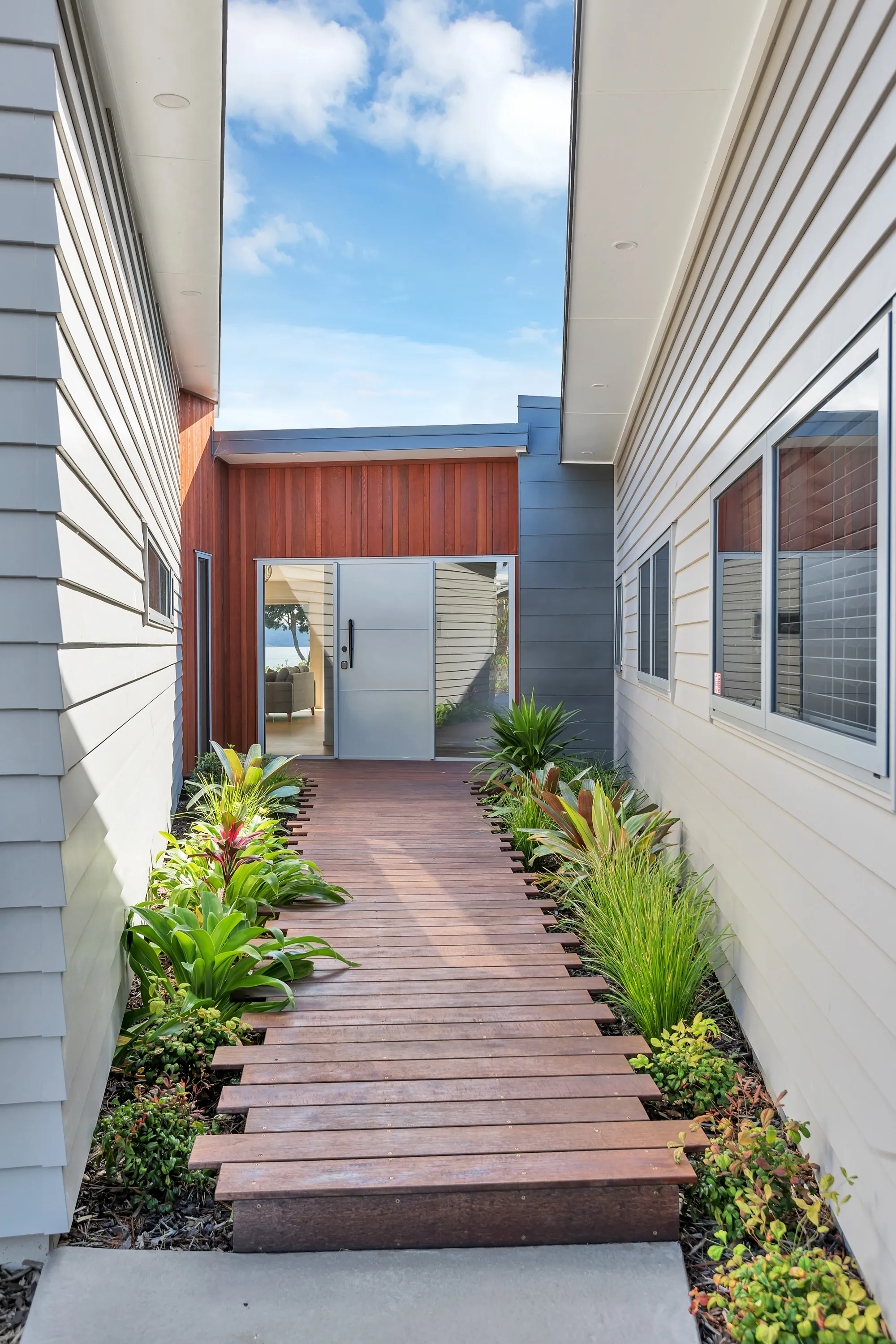 Planted path running alongside a custom Cogan home