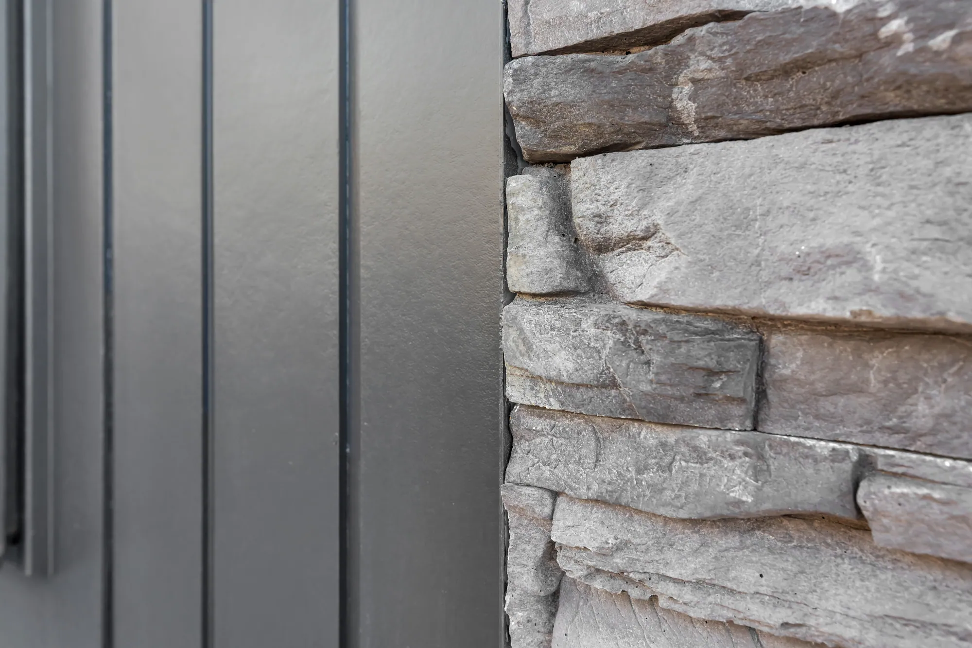 Dry-stacked schist detail against vertical cedar