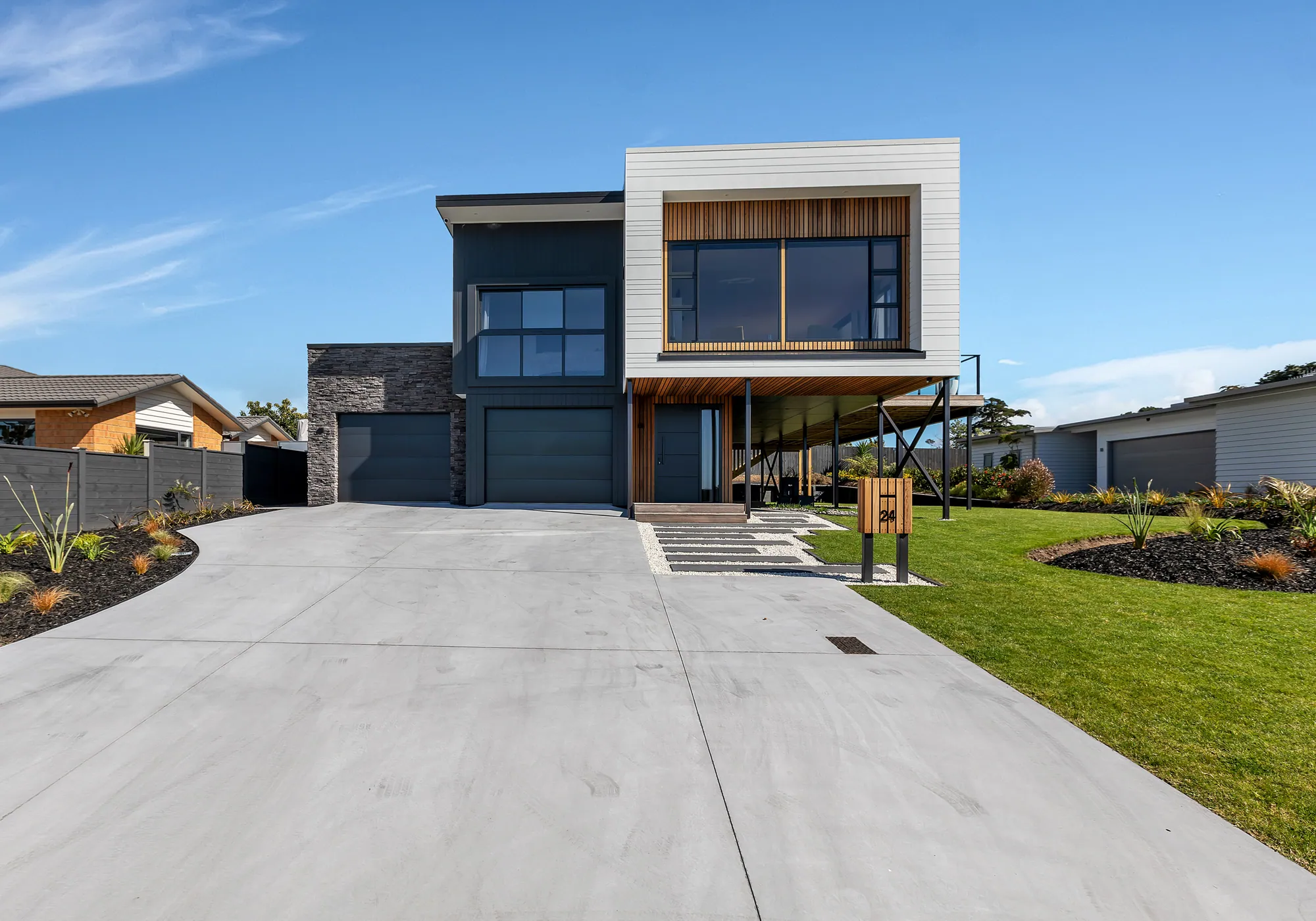 Contemporary two-storey home with cedar and dark cladding, Marsden Cove