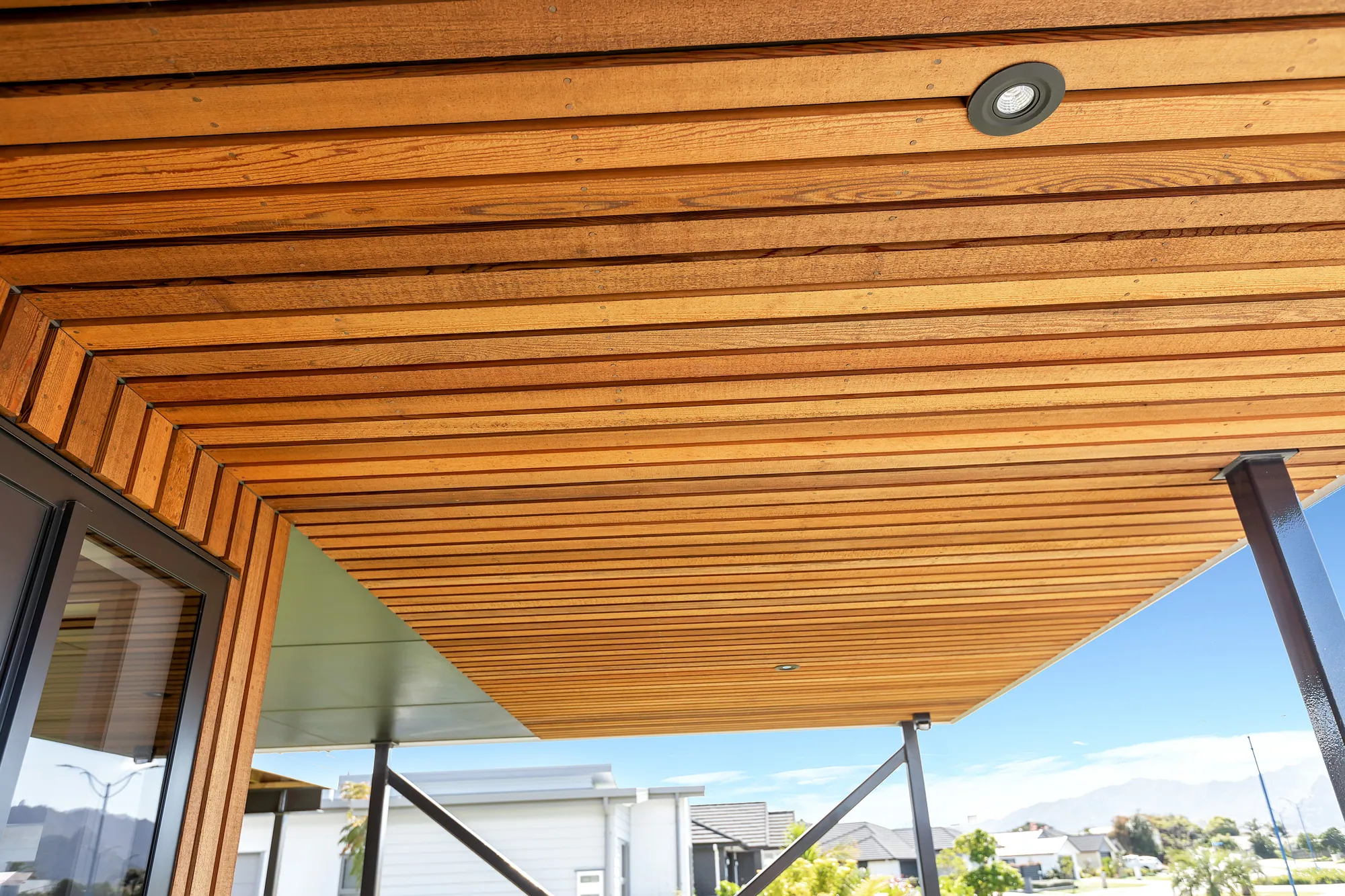 Cedar batten soffit over a covered entry, seen from below