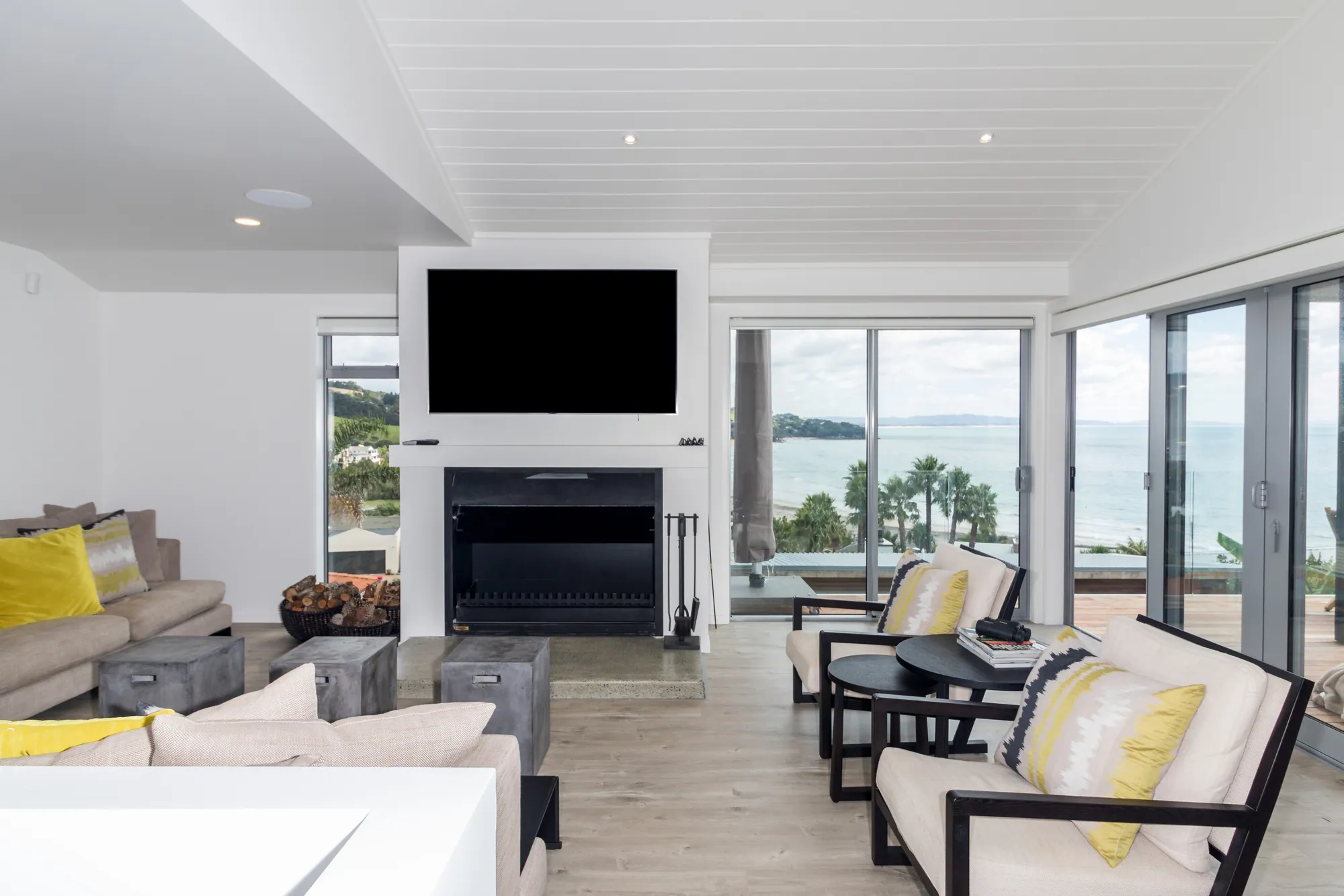Lounge with a fireplace and wide glazing to the sea
