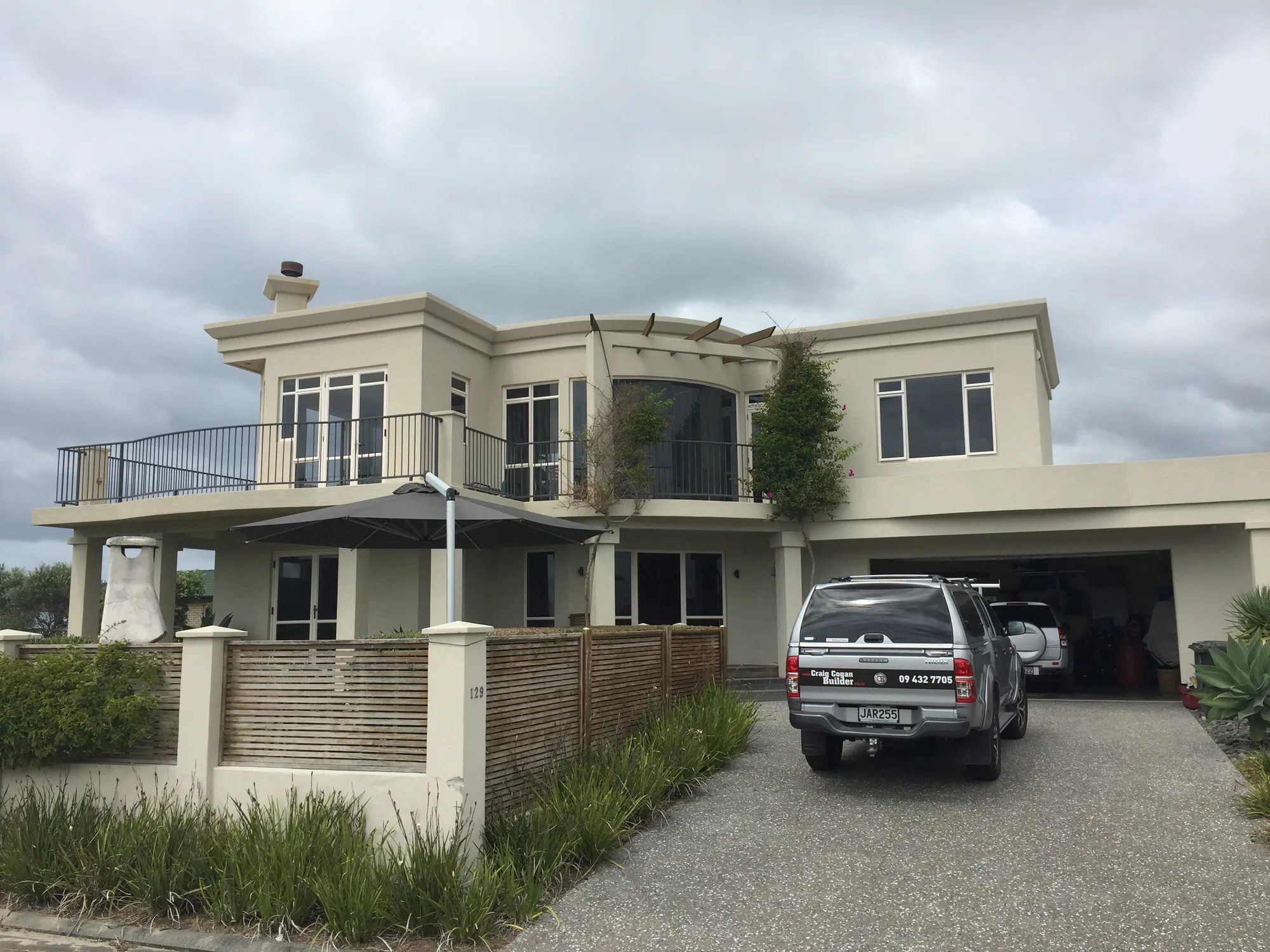 The Bream Bay Drive house before recladding, in its original cream plaster cladding