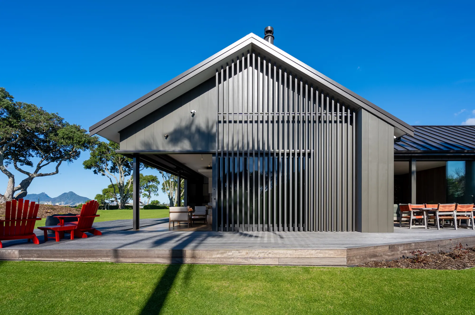 The gable end of the showhome in dark corrugate and cedar