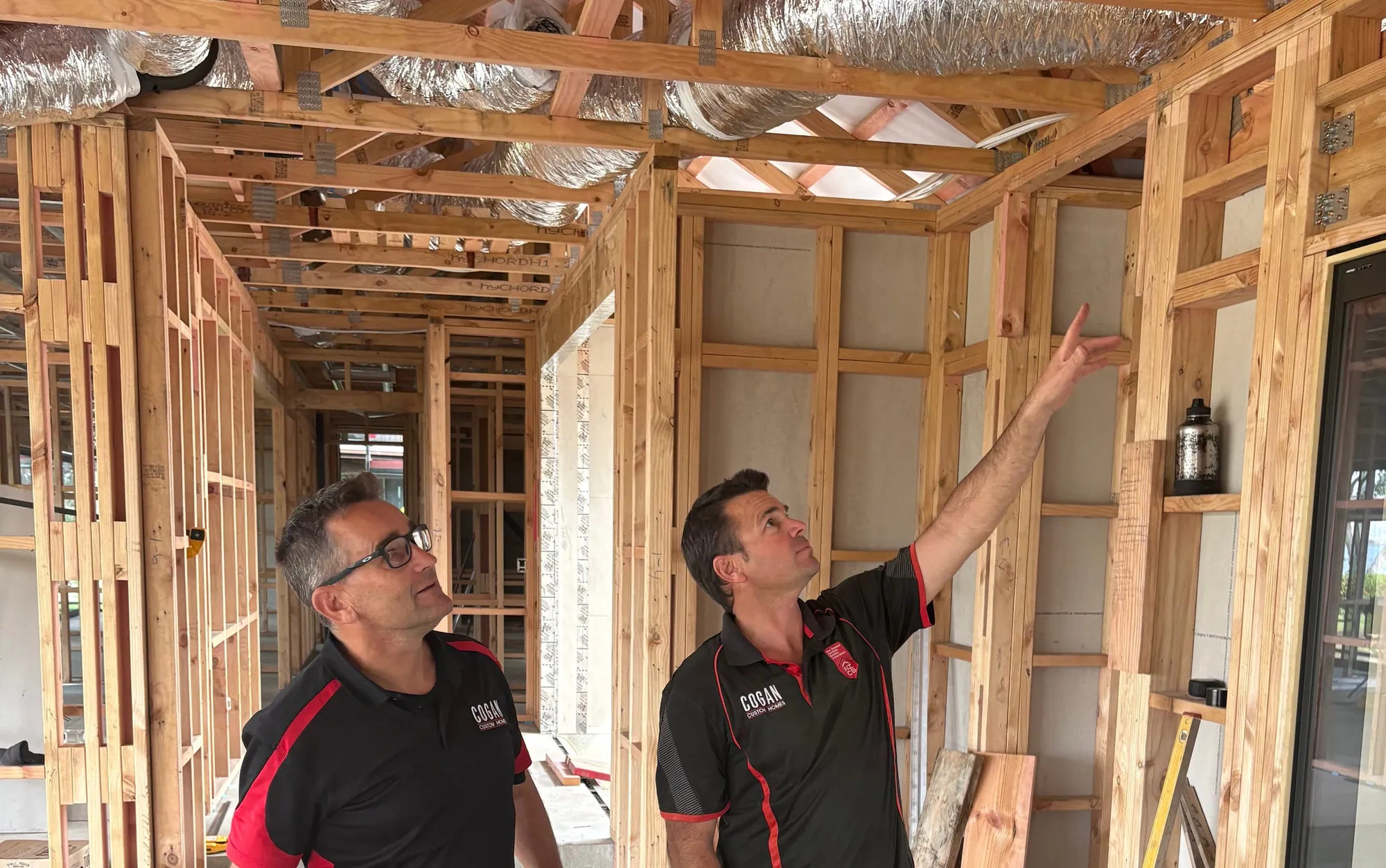 Craig and Simon on site in a Cogan home, checking the roof framing