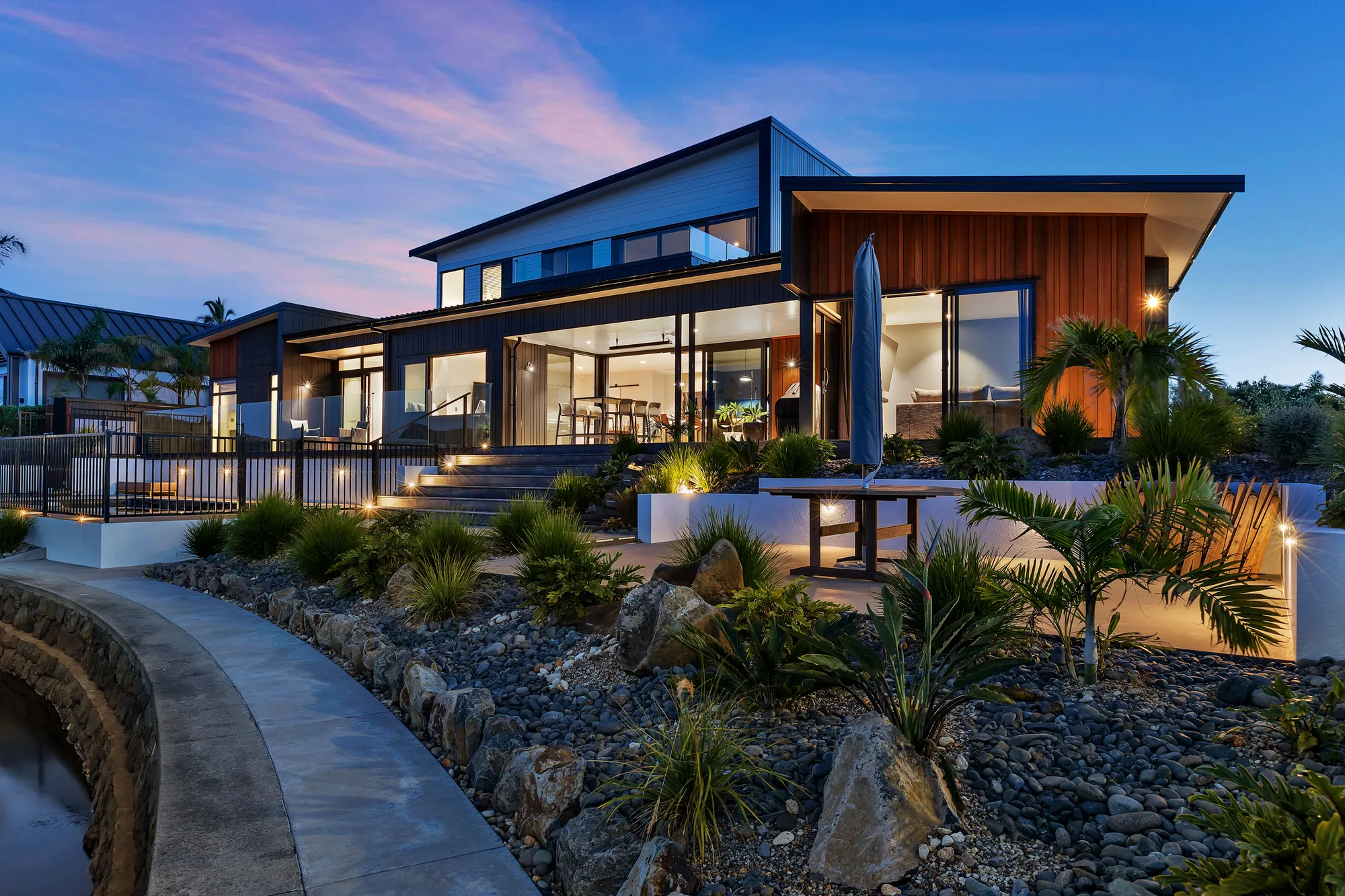 A completed Cogan waterfront home in cedar and dark cladding