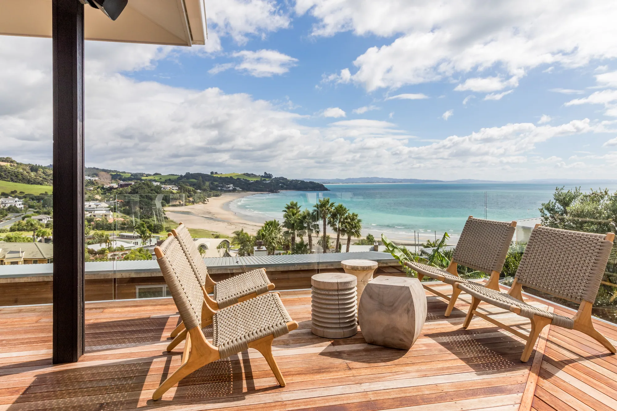 Timber deck and outdoor seating above the beach on a Cogan reclad and renovation