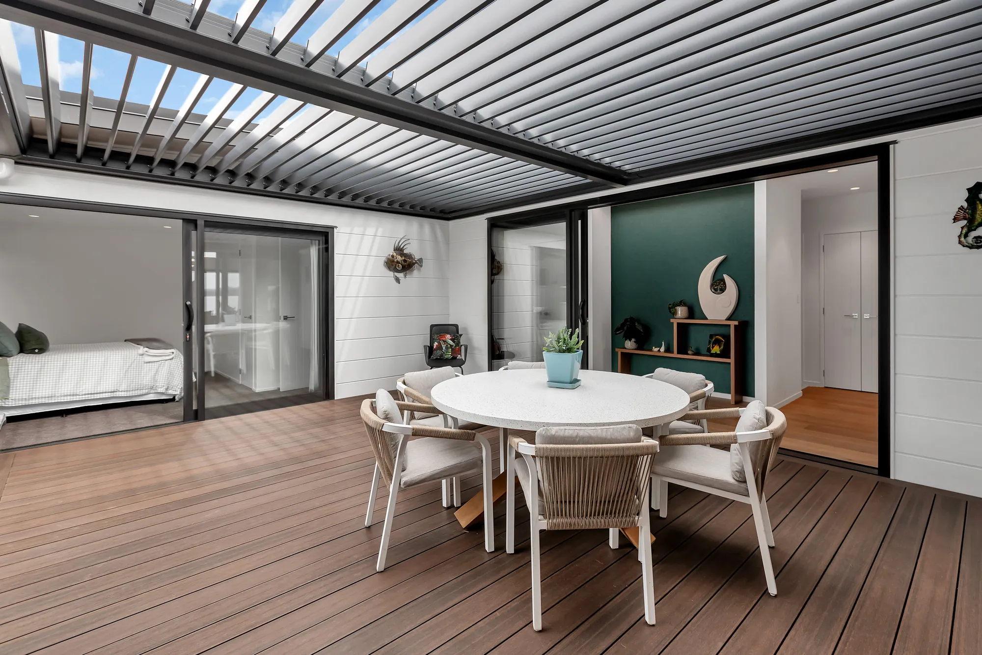 Covered outdoor living and timber deck on a Cogan build