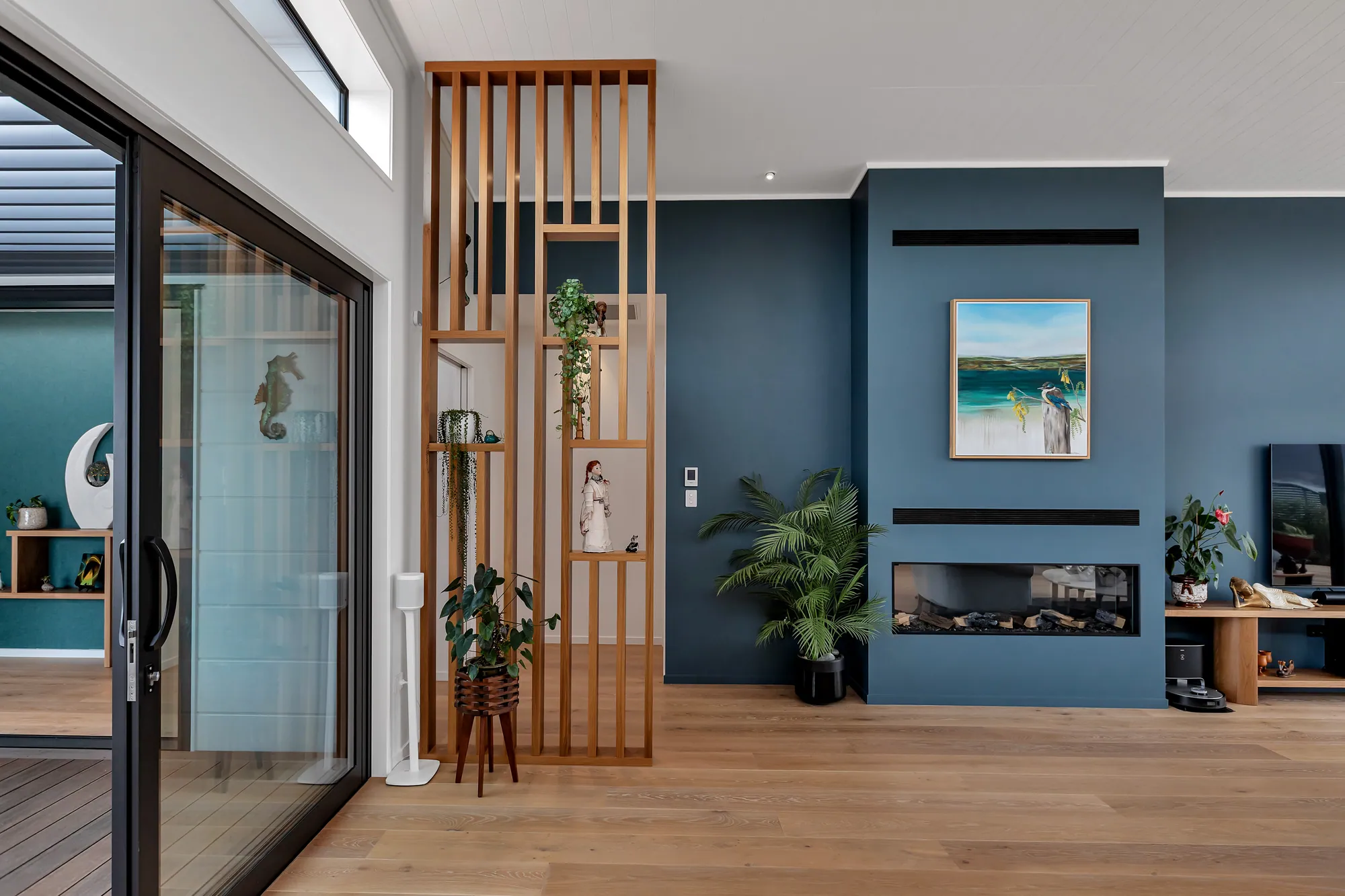 Open-plan living with fireplace and full-height glazing