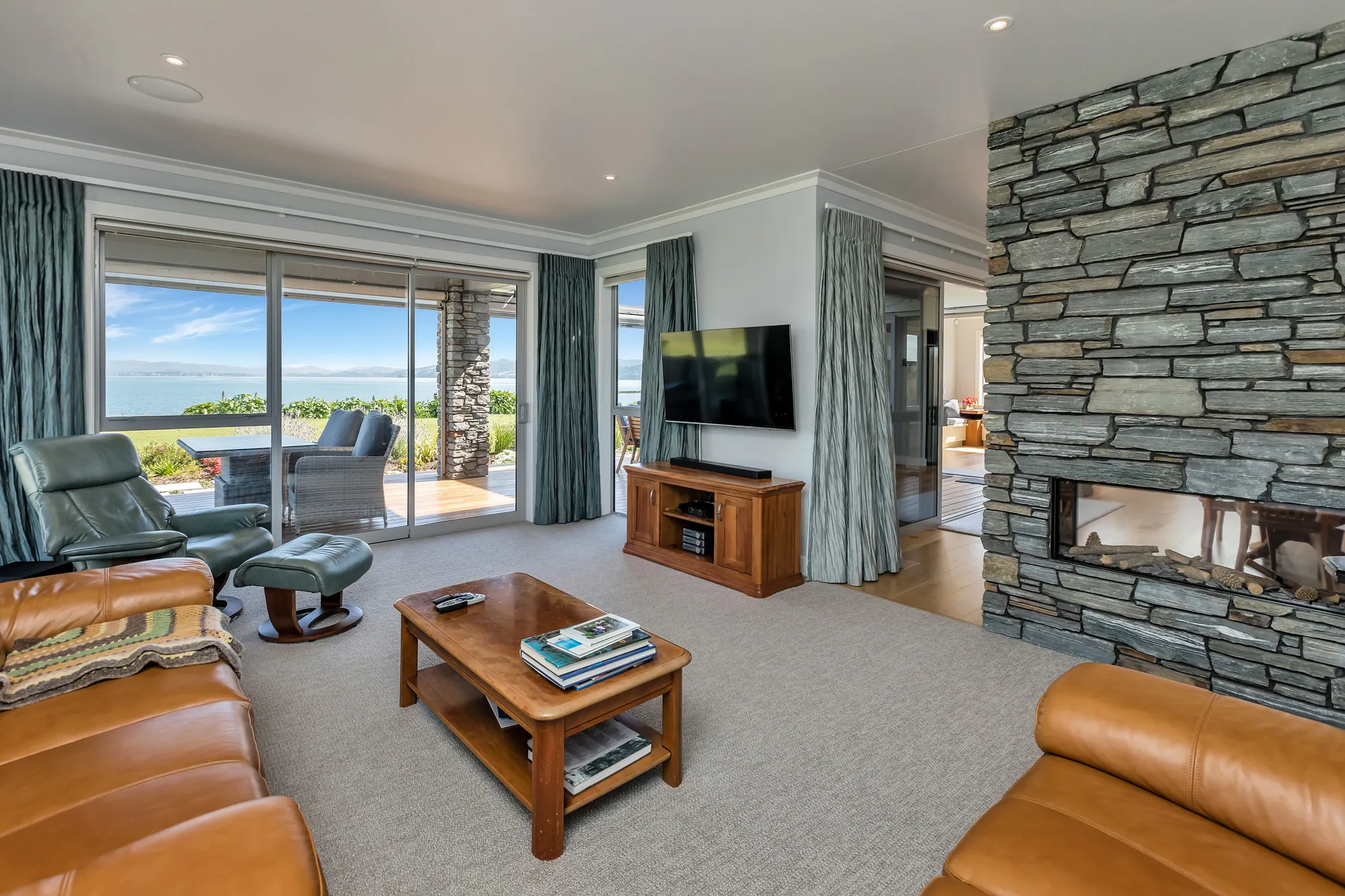 Schist fireplace and living room in a One Tree Point home