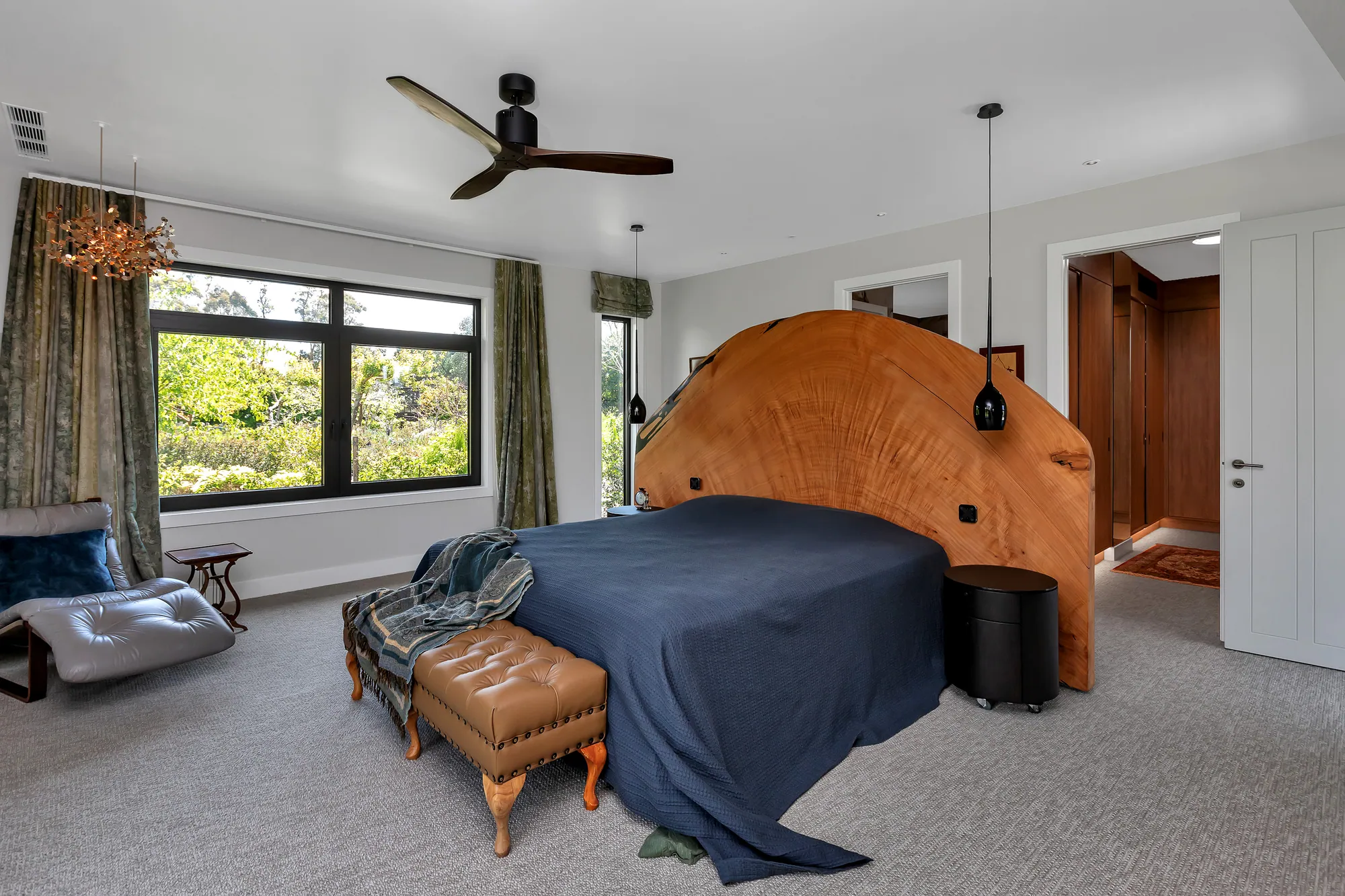 Main bedroom with timber bedhead and garden outlook