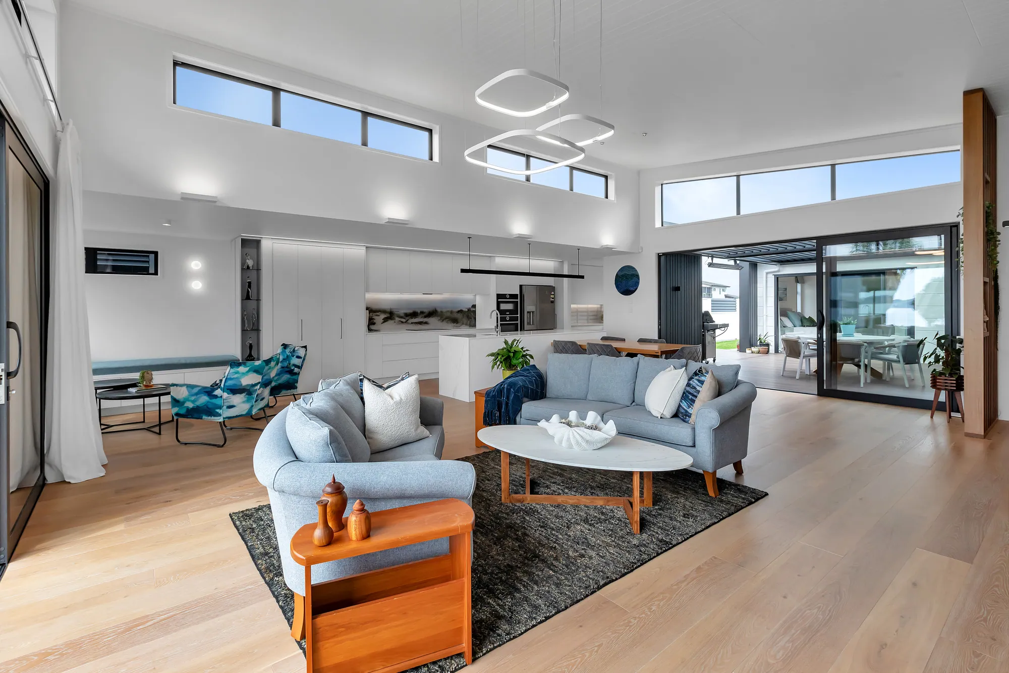 Living room with fireplace and full-height glazing to the water